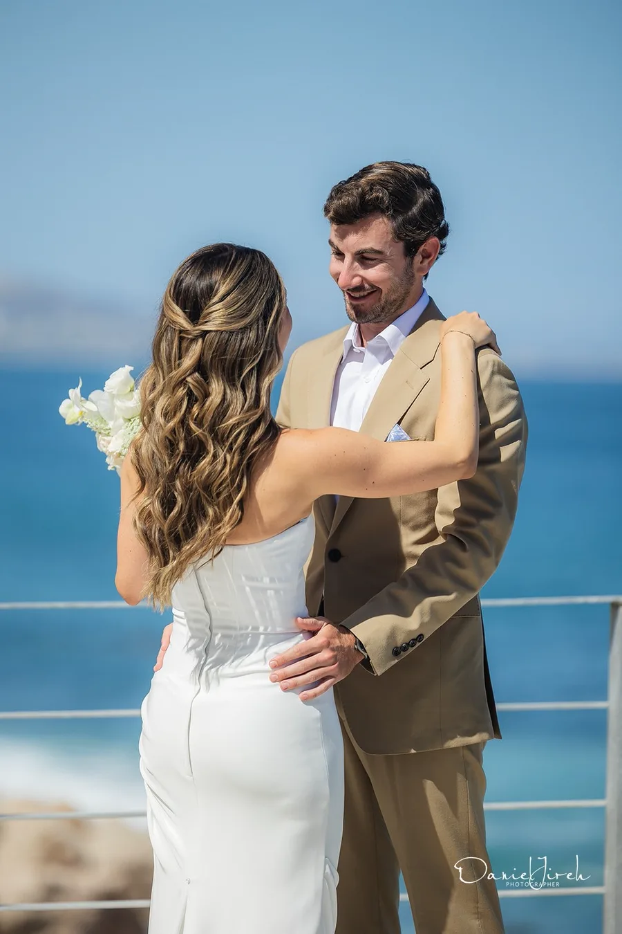 Couple embracing by the ocean